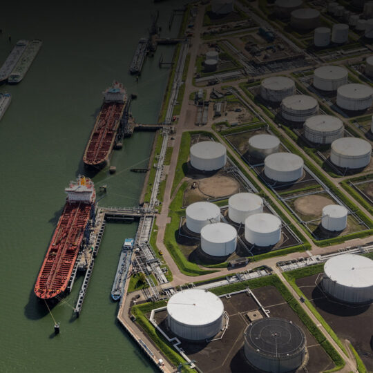 aerial view of oil tankers moored at a oil storage terminal dark